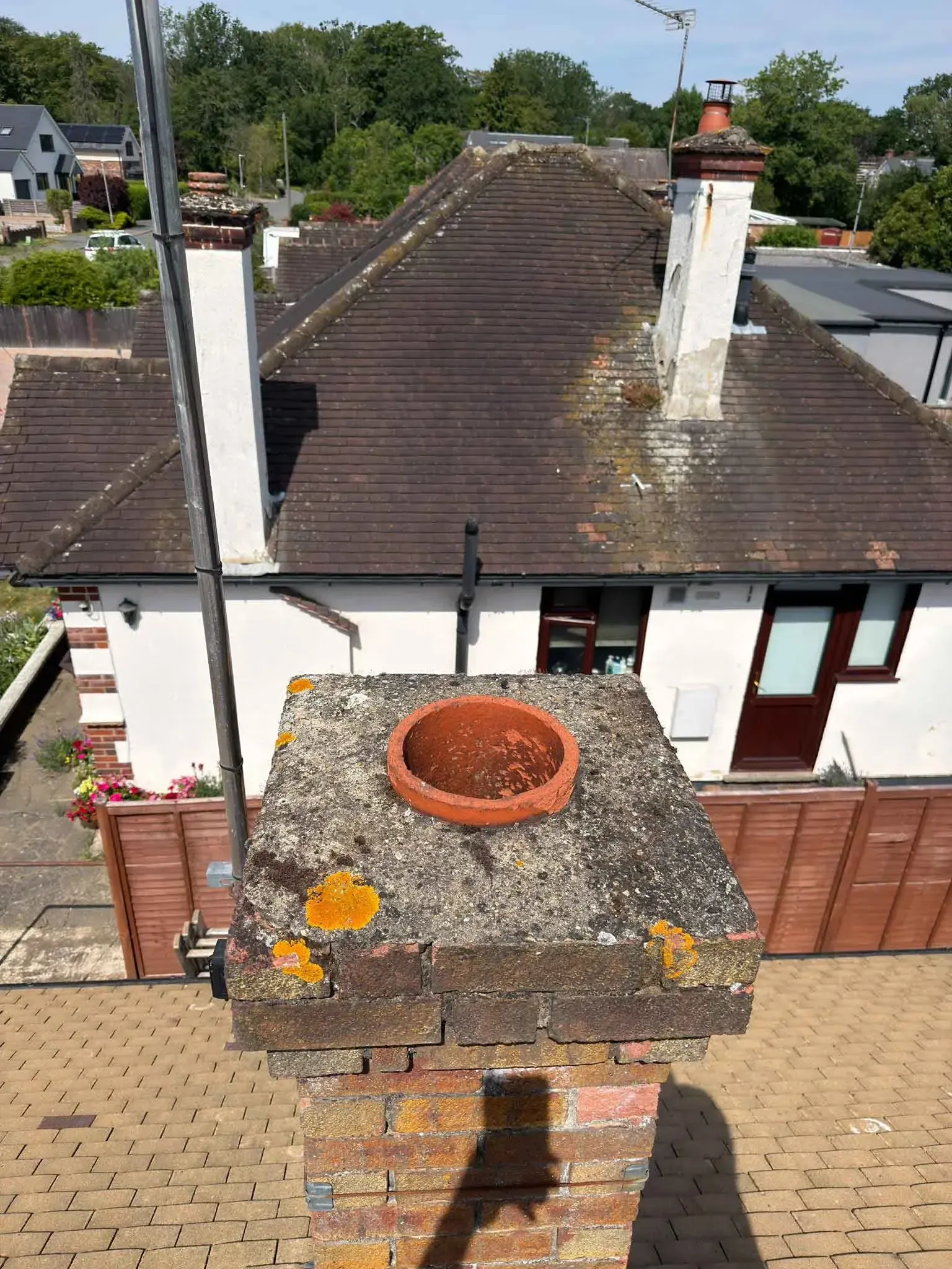 Chimney stack and open chimney pot on the roof of a house in Harrow, Greater London