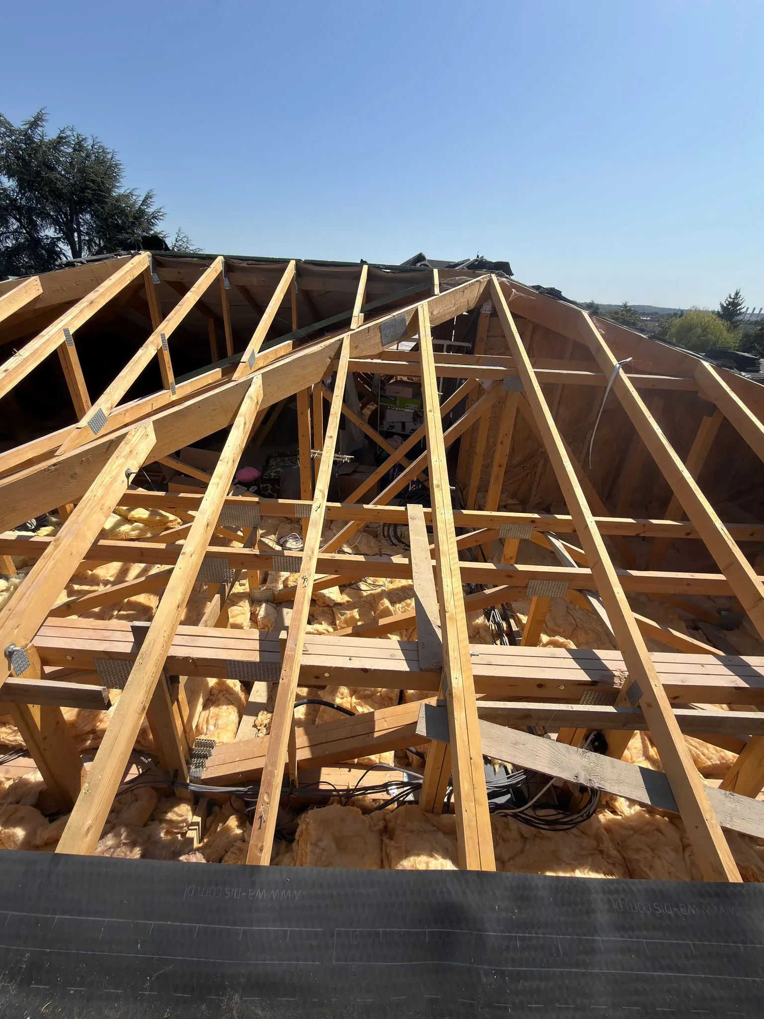 Exposed roof structure and rafters during a roof replacement in Watford, Hertfordshire