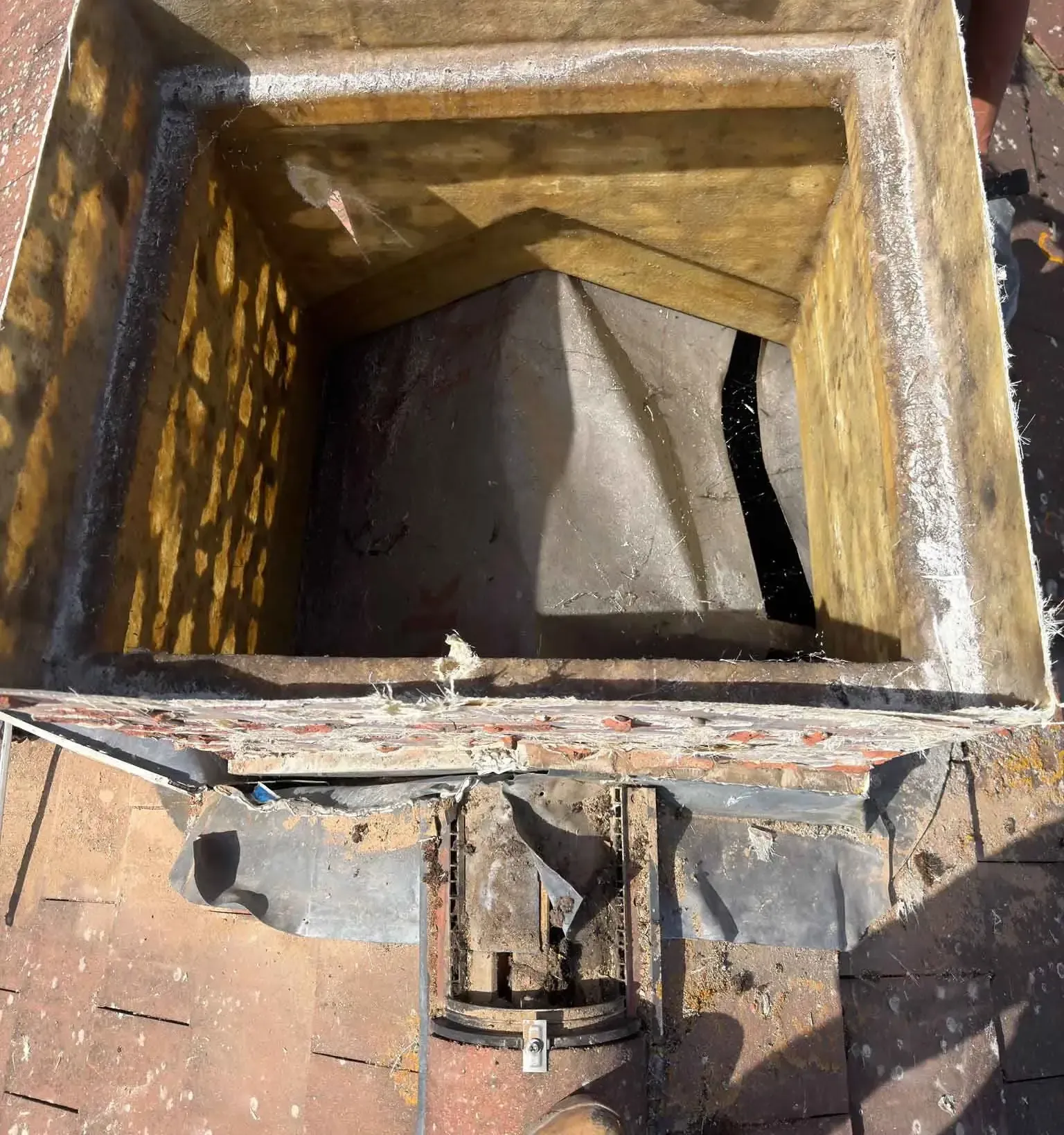 Looking down into the hollow interior of an artificial chimney on a roof in Ascot, Berkshire