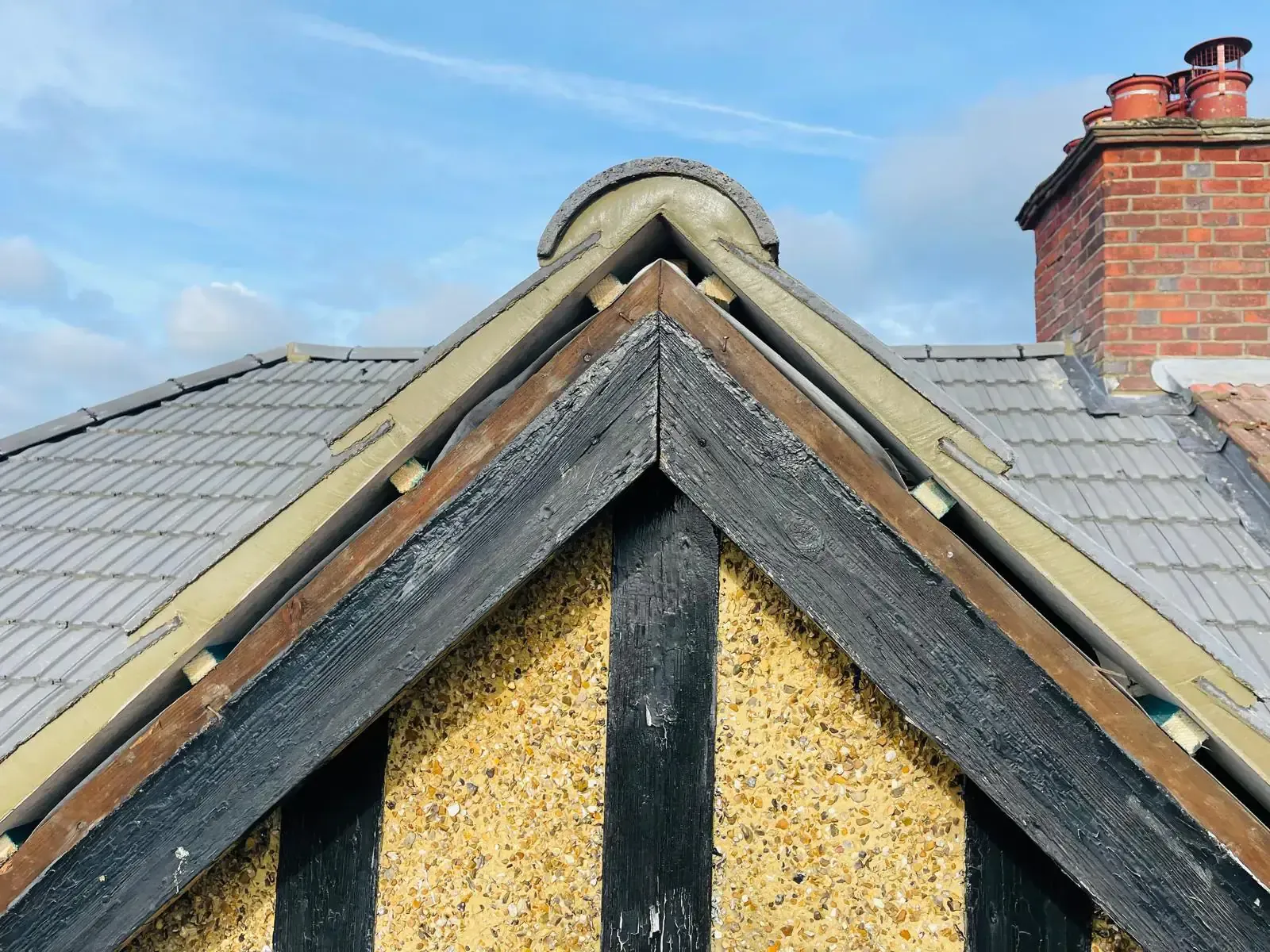 Close view of cement or mortar work and roof-edge detailing at a gable verge in Camberley